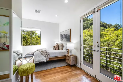 a bedroom with furniture and a window