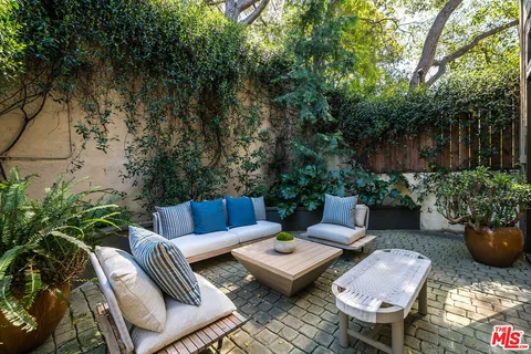 a view of a backyard with furniture and a potted plants
