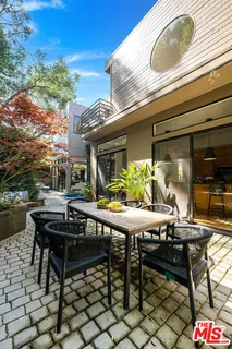 a view of a dinning table and chairs in patio