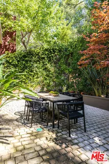 a backyard of a house with table and chairs