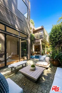 a view of house with swimming pool and outdoor seating
