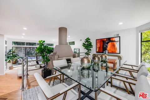 a living room with furniture a rug and a flat screen tv