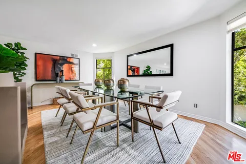 a view of a livingroom and dining room and wooden floor