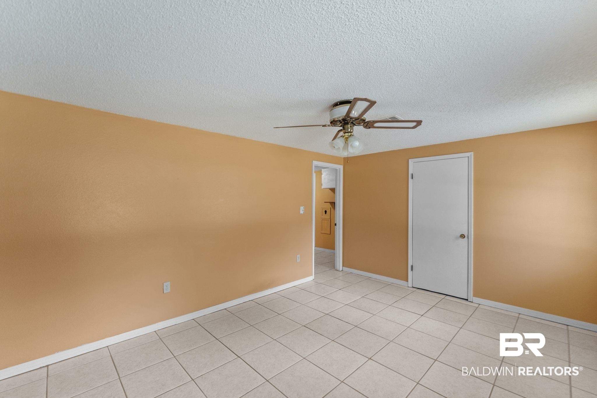 14095 Riverside Drive Foley, AL 36535 - Photo 15 of 30 Empty room with a textured ceiling, a ceiling fan, and light tile patterned flooring