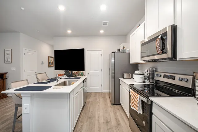 a kitchen with a sink stove and microwave