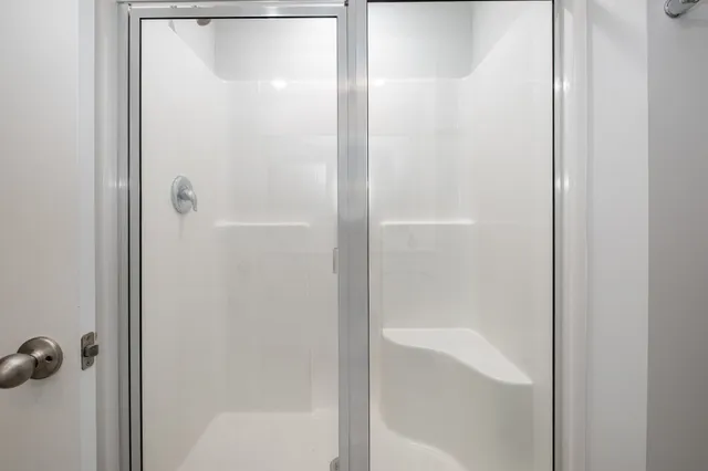 a bathroom with a glass shower door