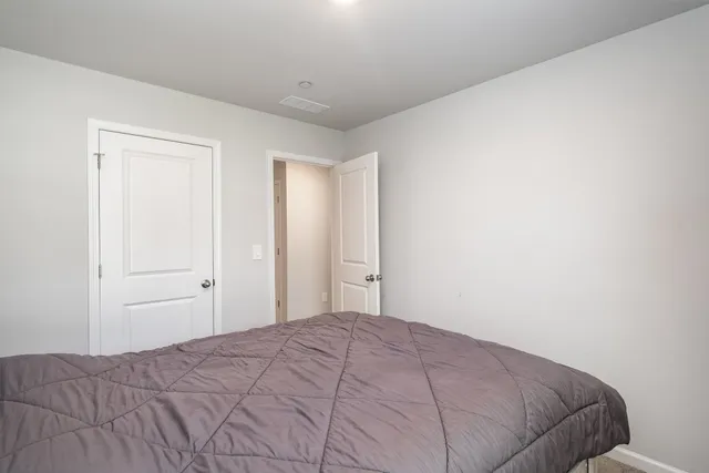 a bedroom with a bed and closet