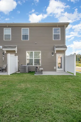 a view of a house with backyard and sitting area