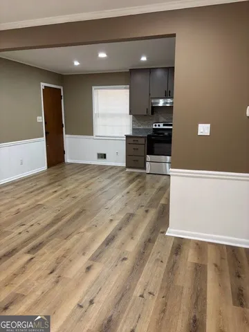 a view of kitchen with kitchen island microwave and stove