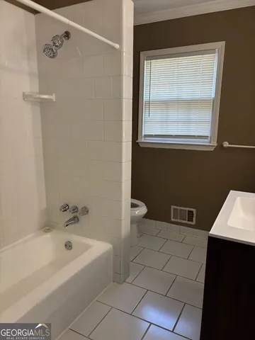 a bathroom with a bathtub a sink a toilet and a vanity