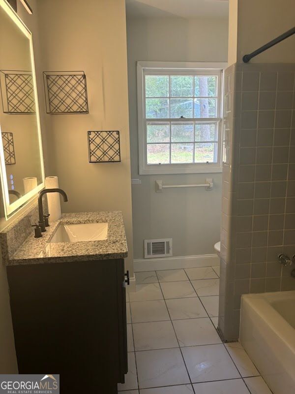 616 Fayetteville Road, Unit 616 & 618 Jonesboro, GA 30236 - Photo 6 of 14 a bathroom with a granite countertop sink a toilet and bathtub