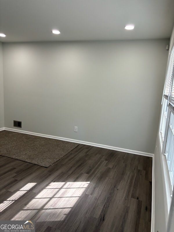 616 Fayetteville Road, Unit 616 & 618 Jonesboro, GA 30236 - Photo 8 of 14 an empty room with wooden floor and windows