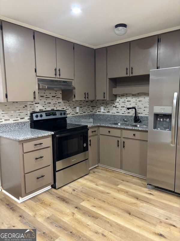 616 Fayetteville Road, Unit 616 & 618 Jonesboro, GA 30236 - Photo 10 of 14 a kitchen with stainless steel appliances granite countertop a stove a sink and a refrigerator
