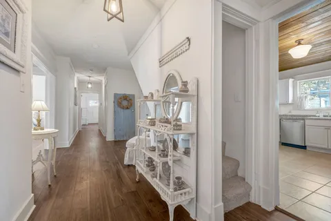 a view of a hallway with wooden floor windows and entryway