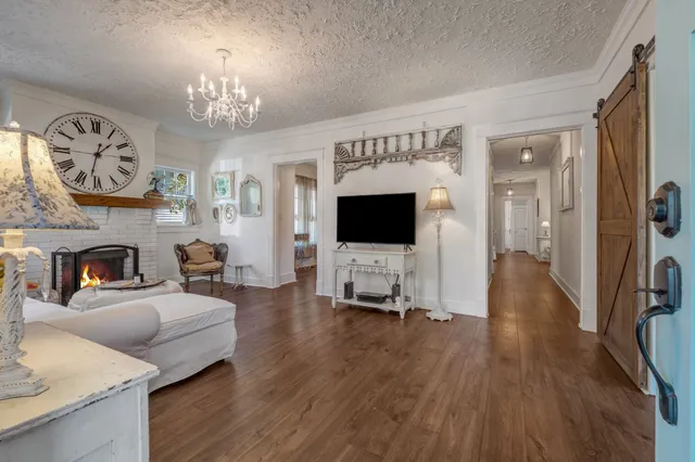 a living room with furniture a fireplace and a flat screen tv