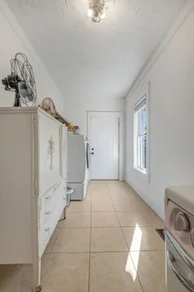 a view of a storage & utility room with closet window