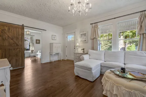 a living room with furniture and a chandelier