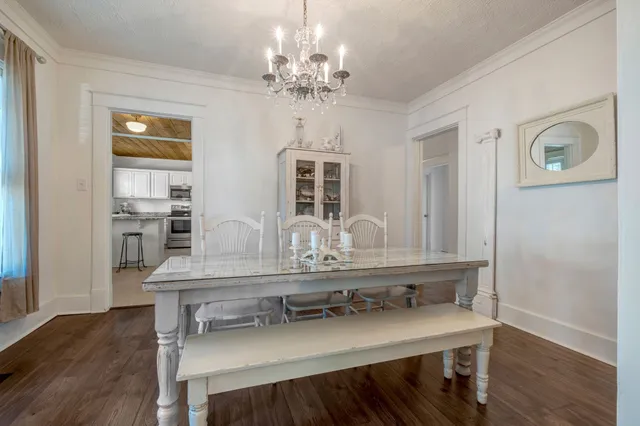 a view of a dining room with furniture and wooden floor