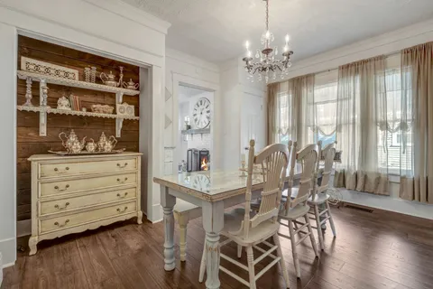 a view of a dining room with furniture and chandelier