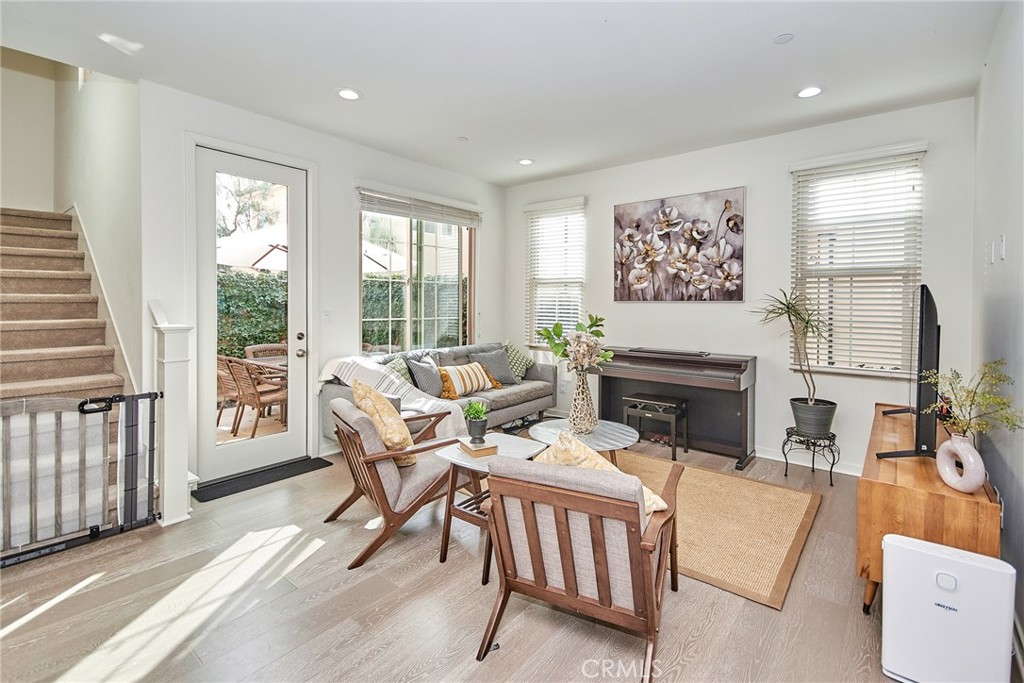 129 Excursion Irvine, CA 92618 - Photo 14 of 53 a living room with furniture a fireplace and a large window