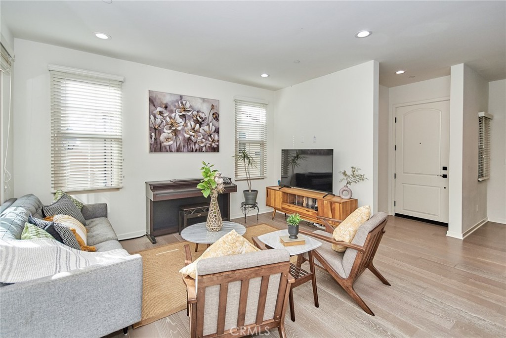 129 Excursion Irvine, CA 92618 - Photo 15 of 53 a living room with furniture a flat screen tv and a large window