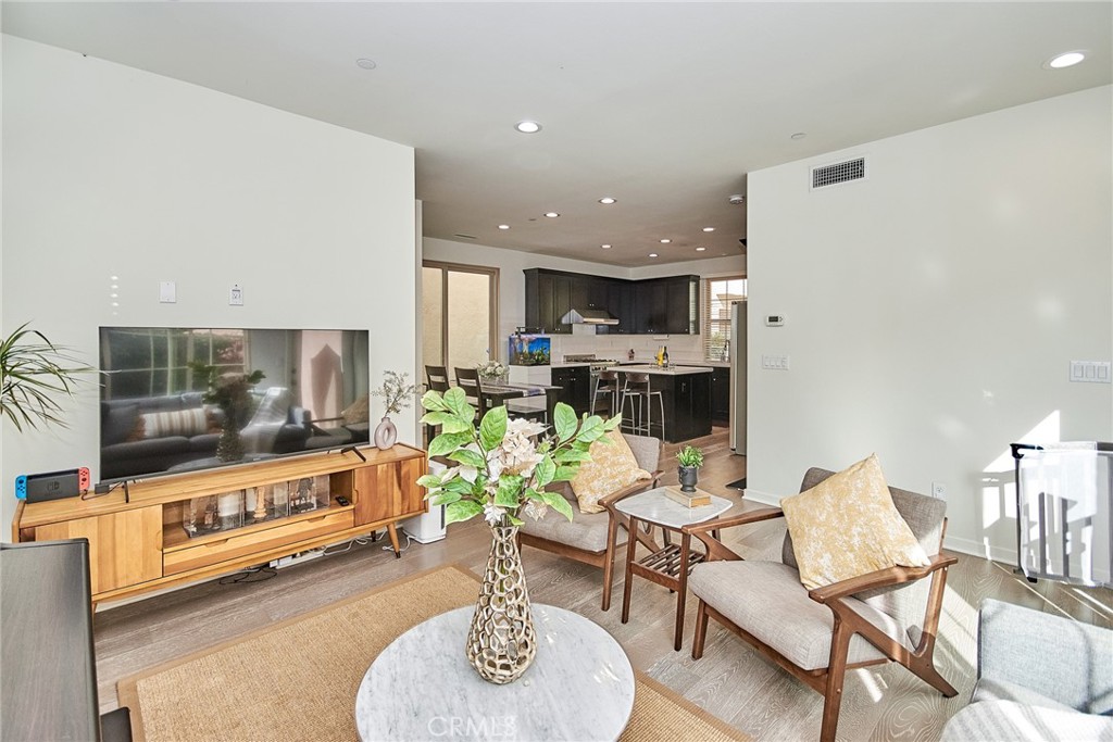 129 Excursion Irvine, CA 92618 - Photo 16 of 53 a living room with furniture and a flat screen tv