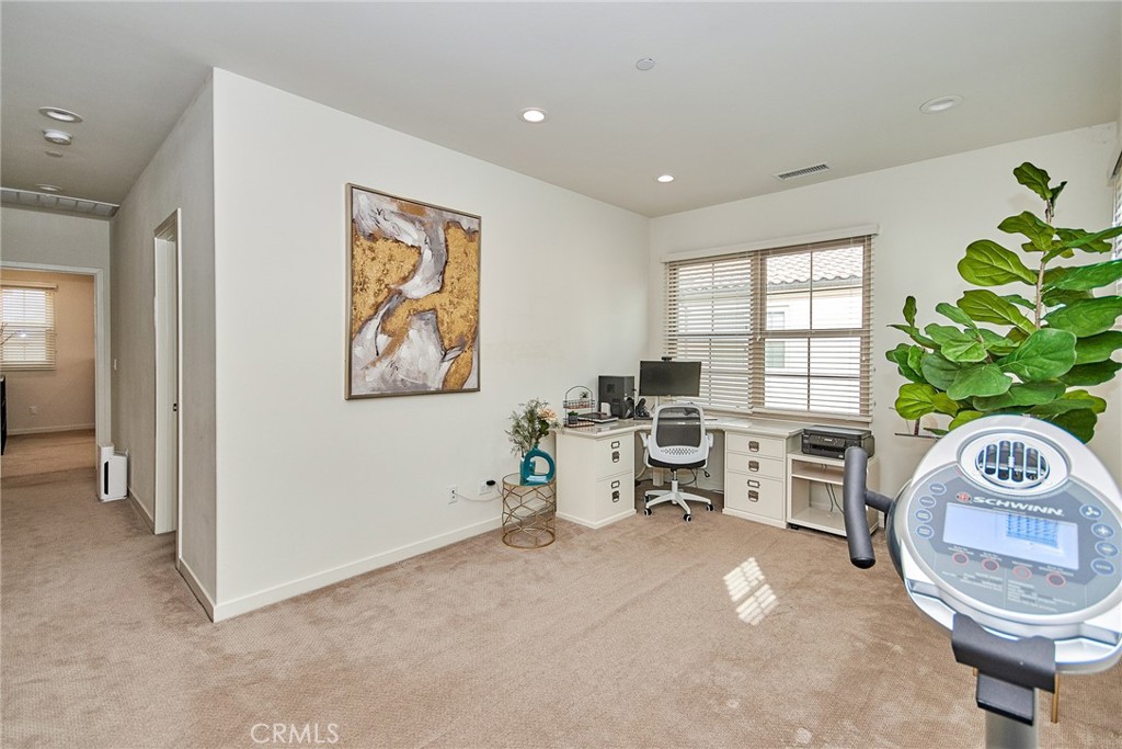 129 Excursion Irvine, CA 92618 - Photo 18 of 53 a view of a workspace with furniture and a potted plant