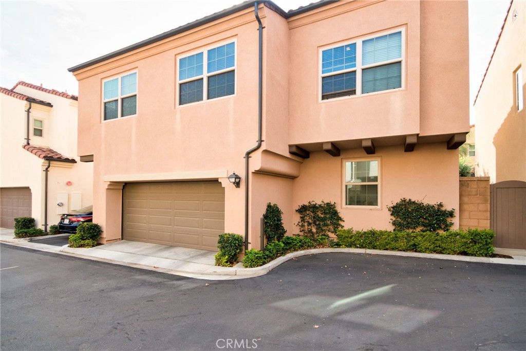 129 Excursion Irvine, CA 92618 - Photo 2 of 53 a front view of a house with a yard and garage