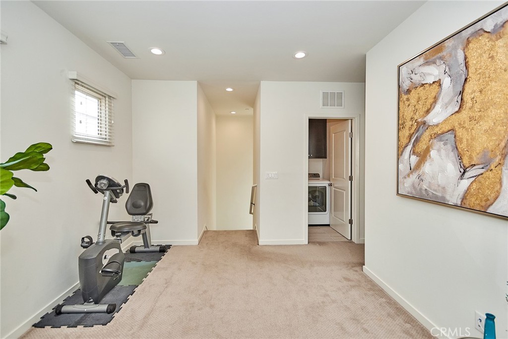 129 Excursion Irvine, CA 92618 - Photo 21 of 53 a view of a room with gym equipment