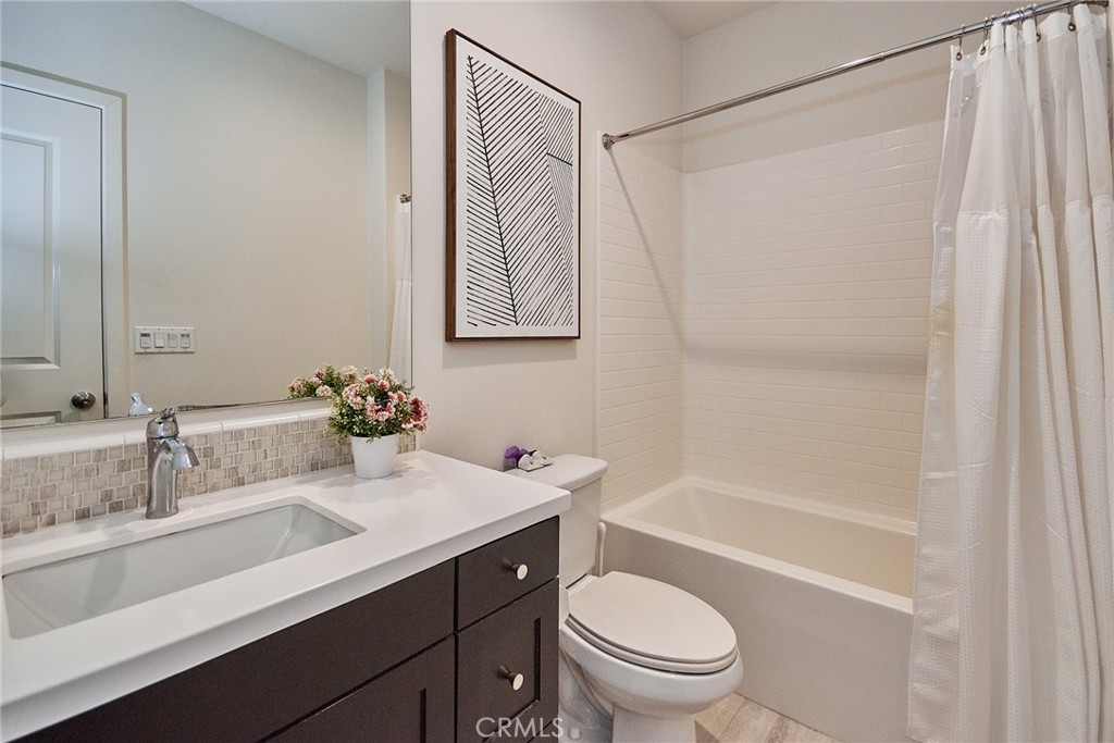 129 Excursion Irvine, CA 92618 - Photo 26 of 53 a bathroom with a sink a toilet and shower