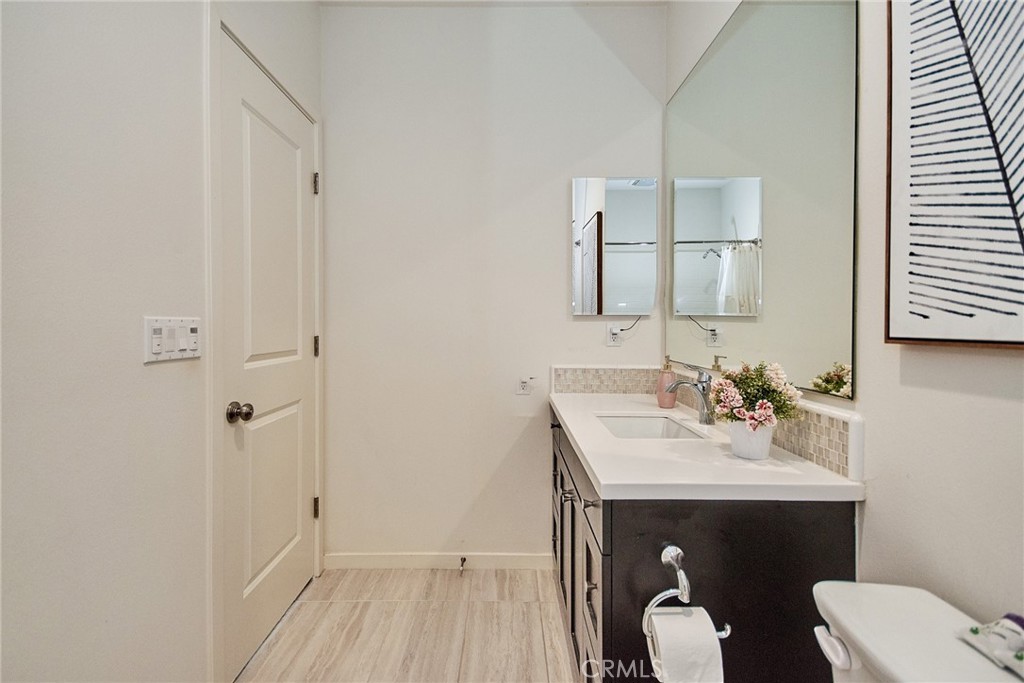 129 Excursion Irvine, CA 92618 - Photo 27 of 53 a bathroom with a sink toilet and vanity