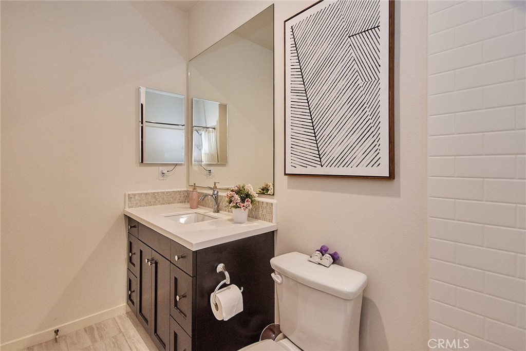 129 Excursion Irvine, CA 92618 - Photo 28 of 53 a bathroom with a sink toilet and a mirror