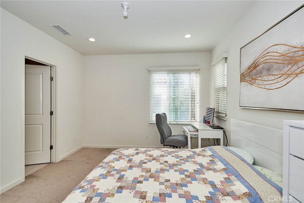 129 Excursion Irvine, CA 92618 - Photo 30 of 53 a bedroom with a bed and wooden floor