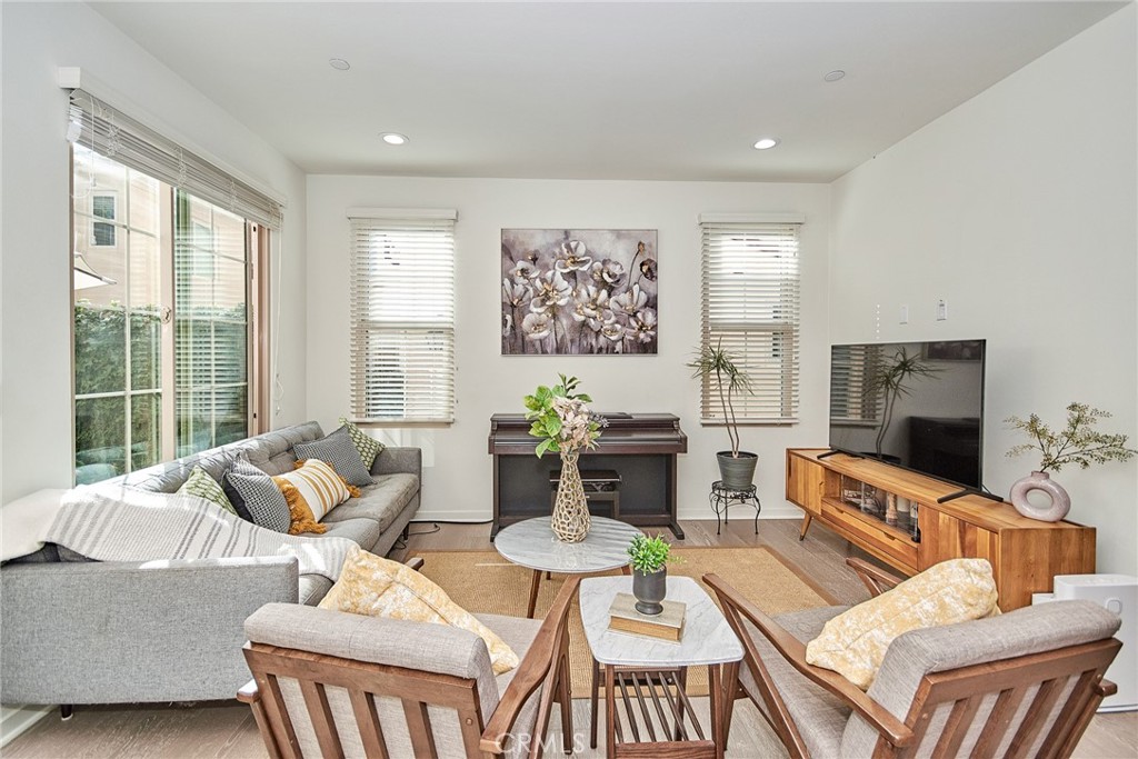 129 Excursion Irvine, CA 92618 - Photo 3 of 53 a living room with furniture and a flat screen tv