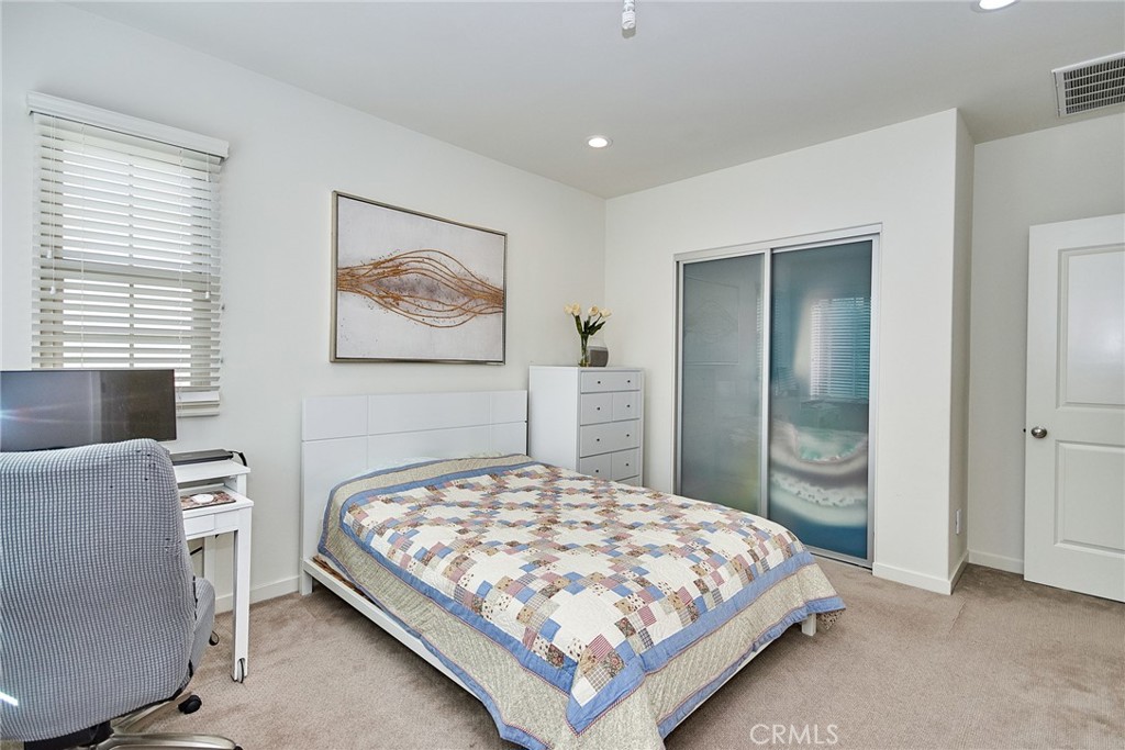 129 Excursion Irvine, CA 92618 - Photo 31 of 53 a bedroom with a bed and a painting on the wall