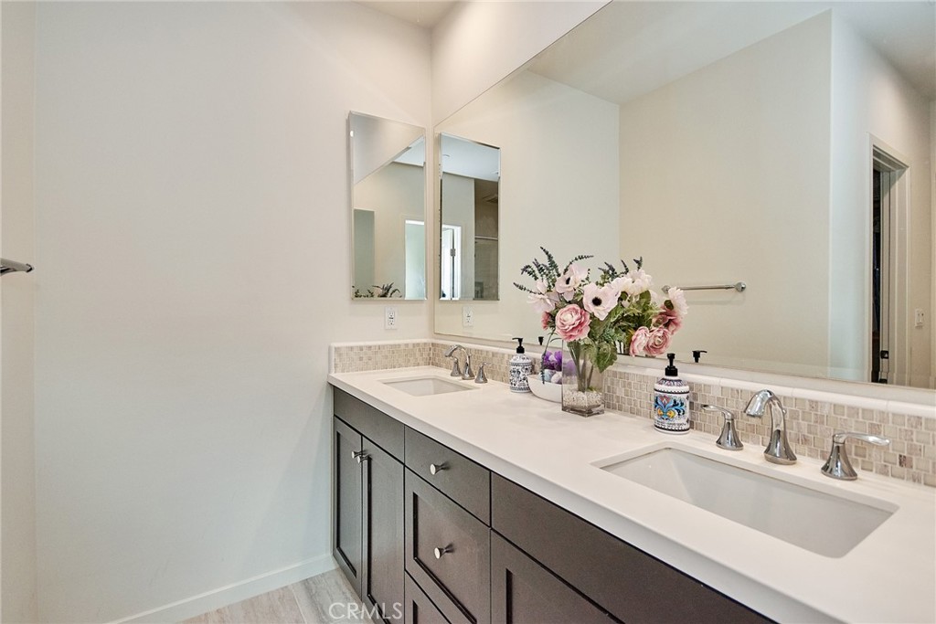 129 Excursion Irvine, CA 92618 - Photo 32 of 53 a bathroom with a sink and a mirror