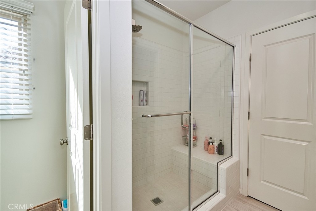 129 Excursion Irvine, CA 92618 - Photo 33 of 53 a bathroom with a shower and a glass door