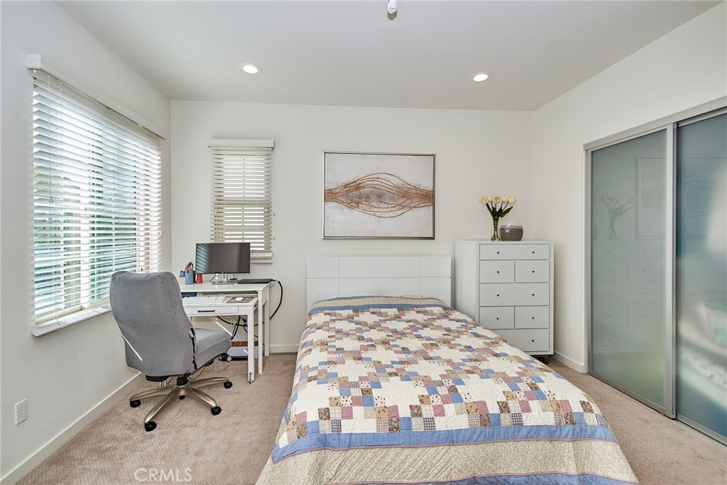 129 Excursion Irvine, CA 92618 - Photo 6 of 53 a bedroom with a bed and chair