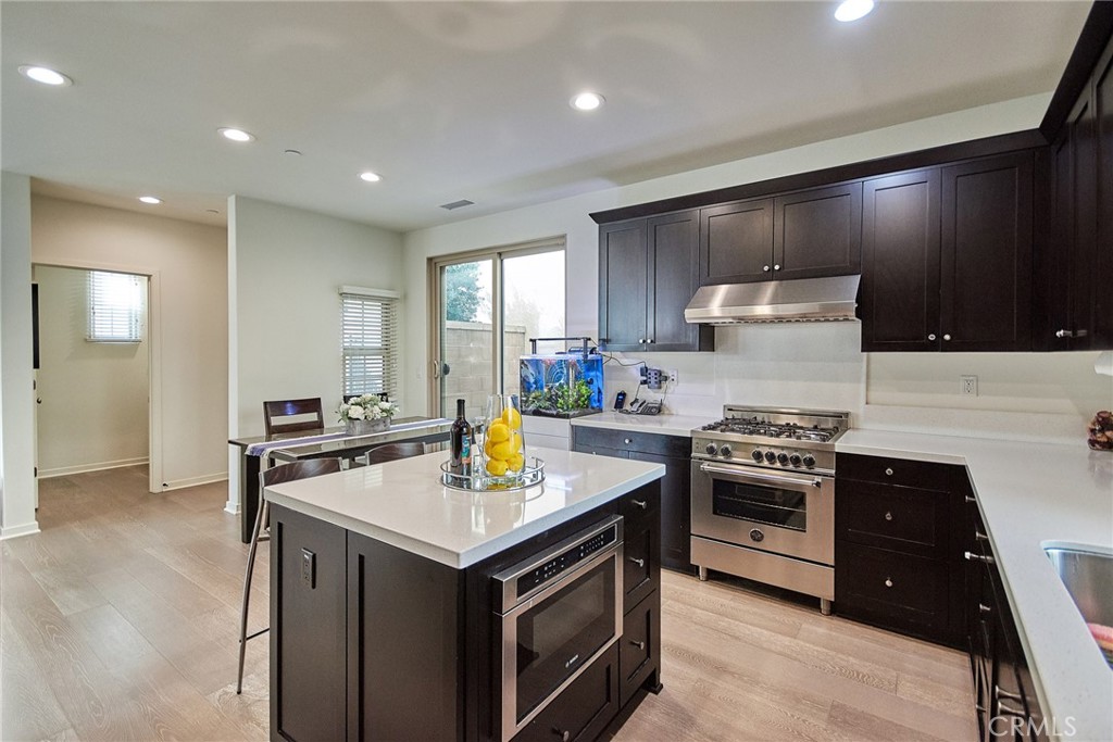129 Excursion Irvine, CA 92618 - Photo 8 of 53 a kitchen with a stove a sink and a refrigerator