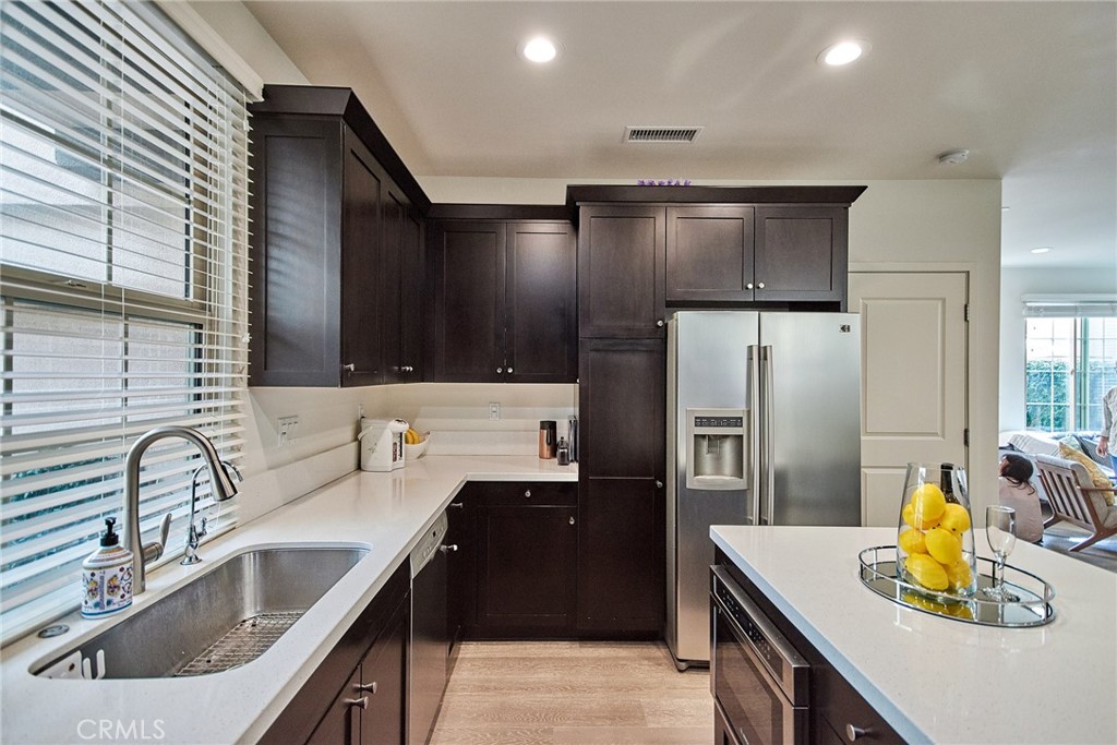 129 Excursion Irvine, CA 92618 - Photo 9 of 53 a kitchen with kitchen island a sink appliances and cabinets