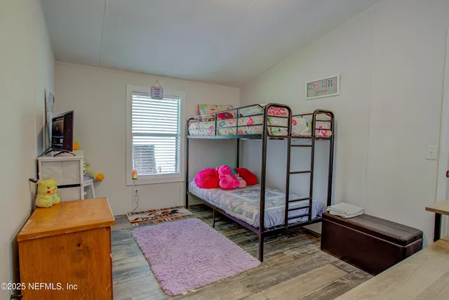 a living room with furniture a flat screen tv and a floor