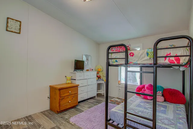 a bedroom with a bed a dresser and book self