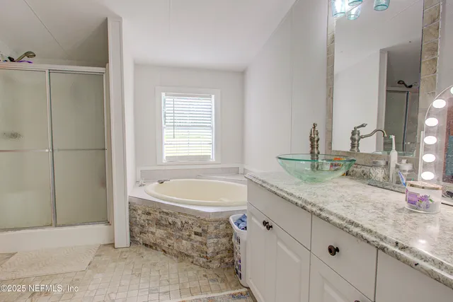 a bathroom with a granite countertop sink a toilet and bathtub