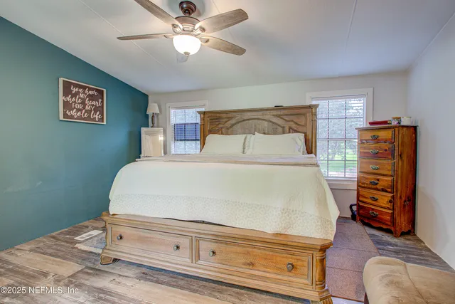 a bedroom with a bed and a television