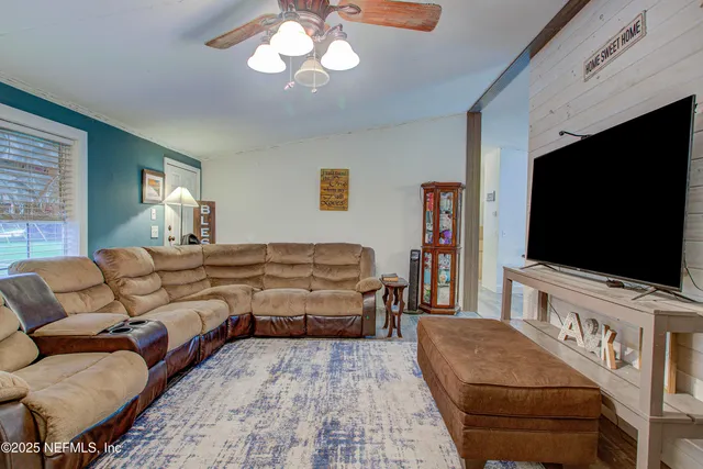 a living room with furniture and a chandelier