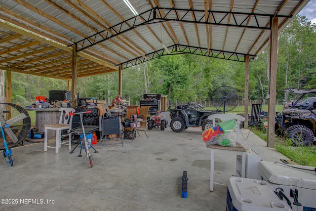 a view of a chairs and tables in the back yard of the house