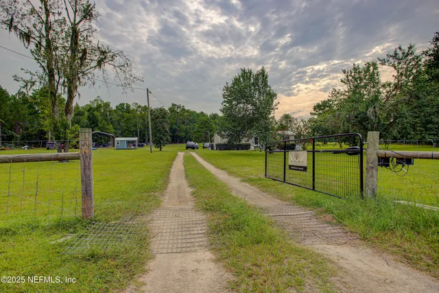 a backyard of a house with table and chairs