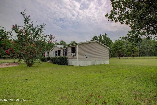 a view of a house with a backyard