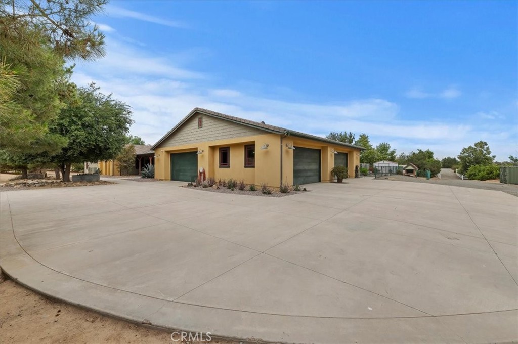 16420 Rocky Glen Road Perris, CA 92570 - Photo 6 of 74 a front view of a house with a yard and trees