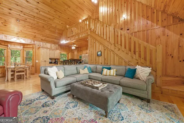 a living room with furniture and a chandelier